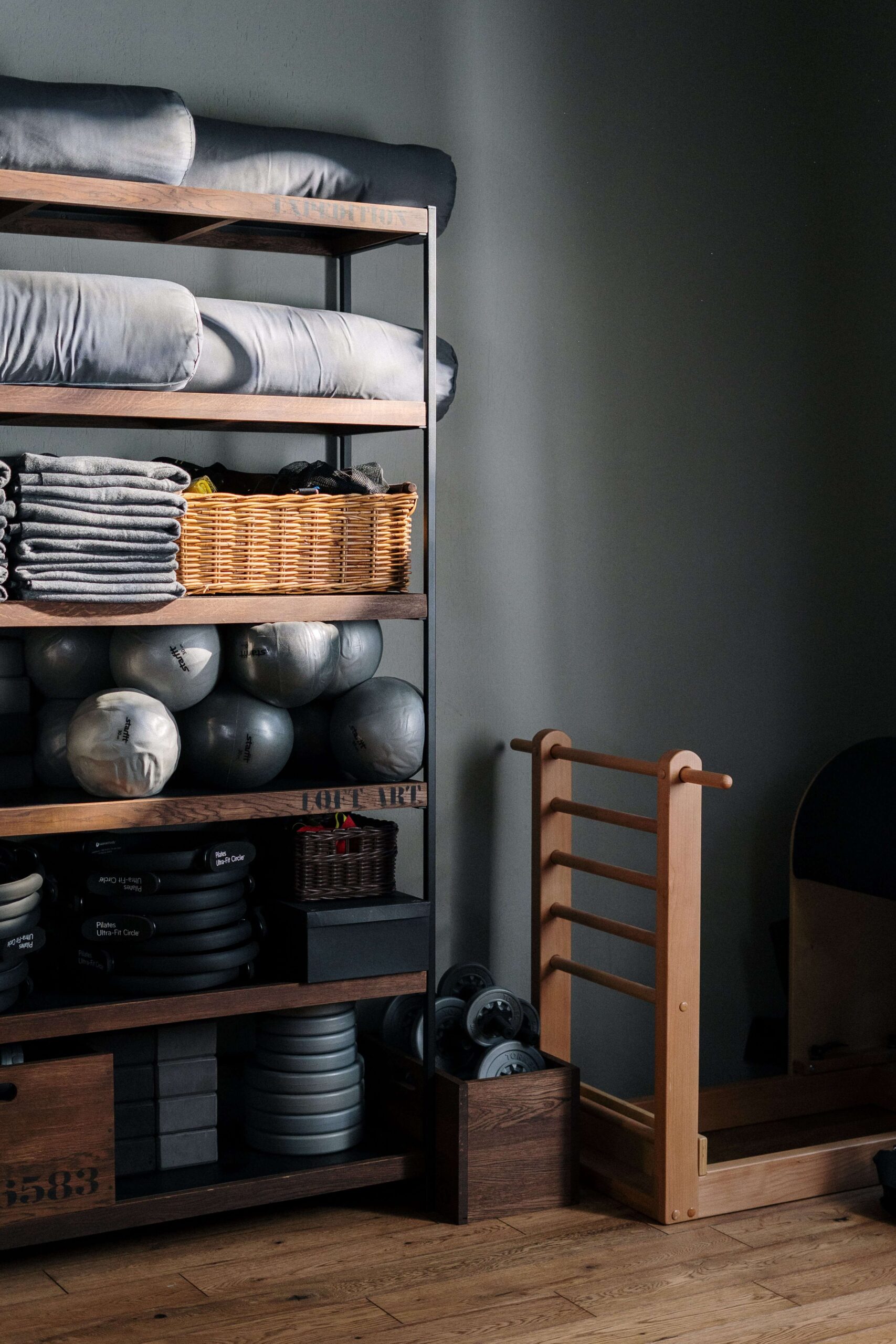 4. Clean your home by categorizing. shows gym equipment on a shelves grouped by item, use, and size.